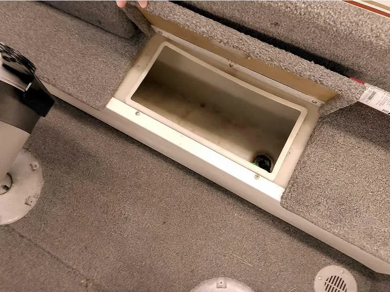 Slide: The Image of 2006 Crestliner 1850 Fish Hawk DC boat storage compartment with open lid, showing interior space. - 29