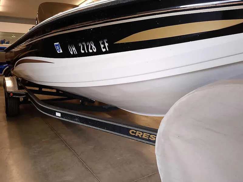 Slide: The Image of 2006 Crestliner 1850 Fish Hawk DC boat on trailer, black and white design. - 3