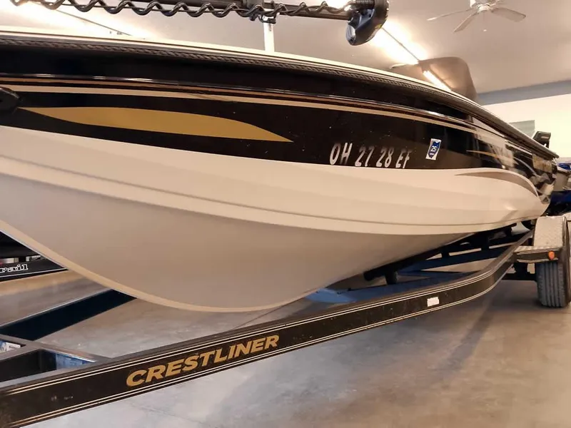 Slide: The Image of 2006 Crestliner 1850 Fish Hawk DC boat on trailer in garage. - 4