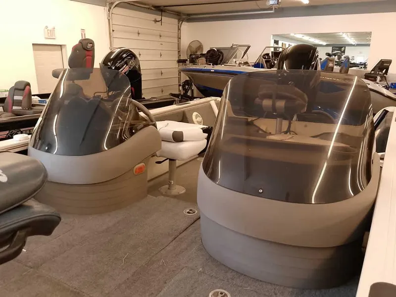 Slide: The Image of 2006 Crestliner 1850 Fish Hawk DC boat interior with dual consoles in a garage setting. - 9