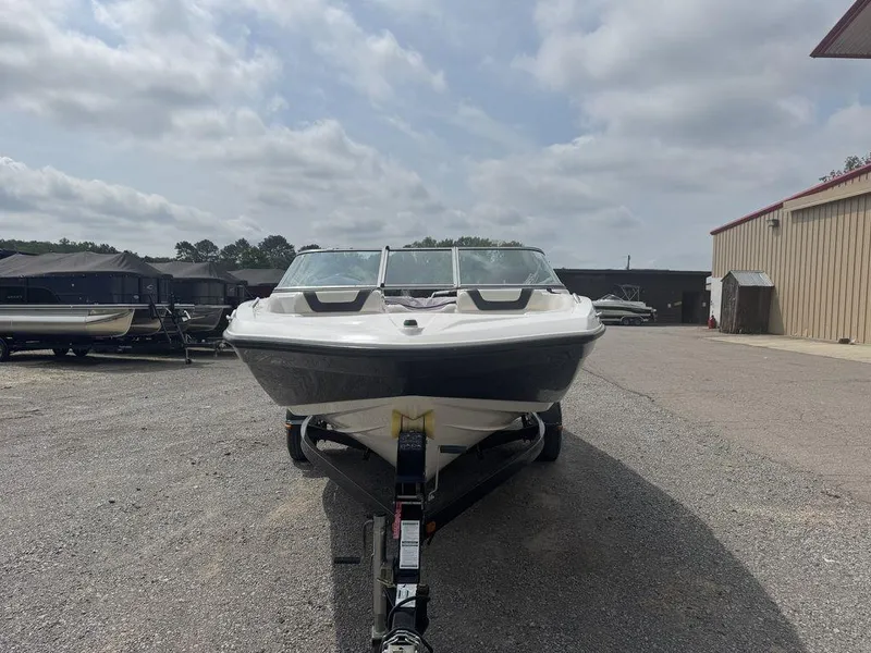 Slide: The Image of 2013 Yamaha Boats SX190 on trailer, parked outdoors under cloudy sky. - 2