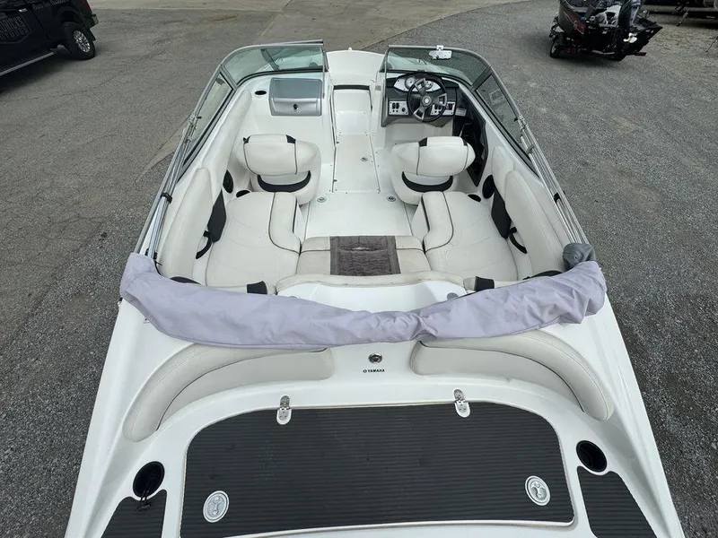 Slide: The Image of 2013 Yamaha Boats SX190 interior with white seating and steering console. - 8