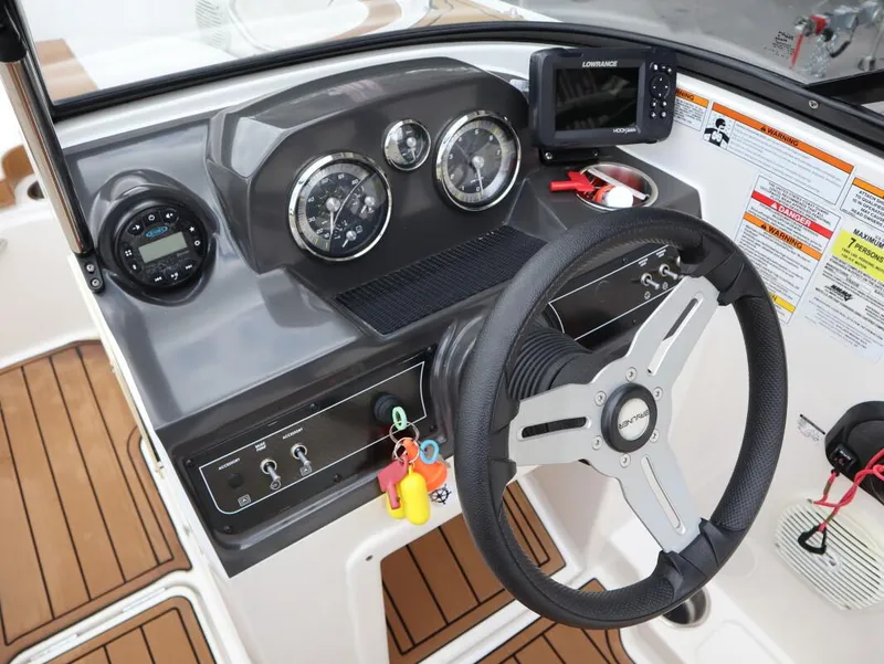 Slide: The Image of 2022 Bayliner VR4 Bowrider Outboard dashboard with steering wheel and gauges. - 10
