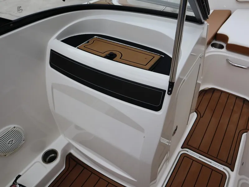 Slide: The Image of 2022 Bayliner VR4 Bowrider Outboard interior with brown and white seating and flooring. - 12