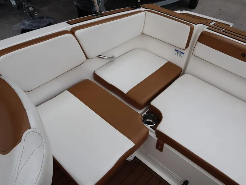 Slide: The Image of 2022 Bayliner VR4 Bowrider Outboard interior with white and brown cushioned seating. - 13
