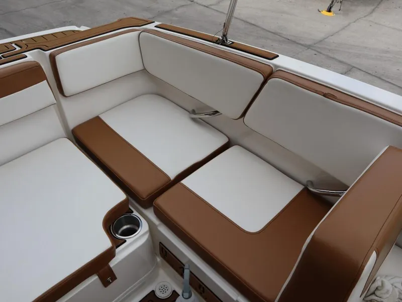 Slide: The Image of 2022 Bayliner VR4 Bowrider Outboard interior seating with brown and white cushions. - 14