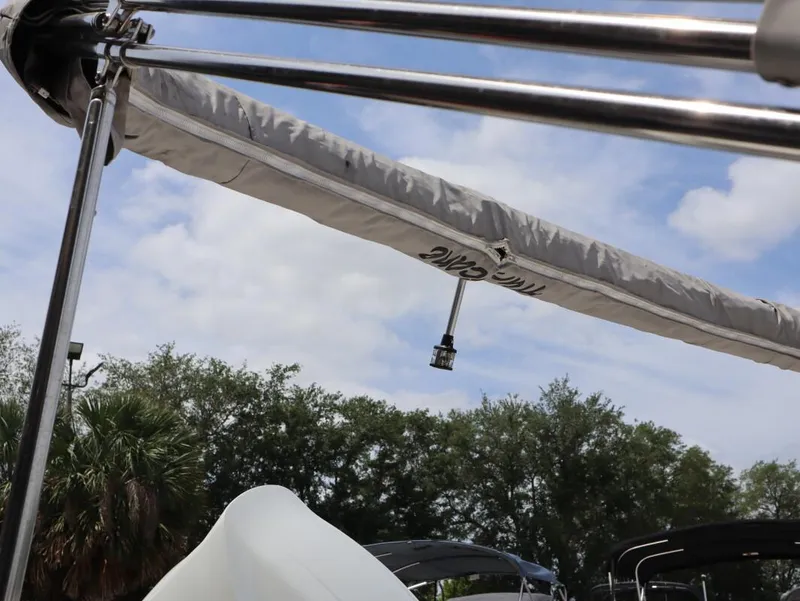 Slide: The Image of 2022 Bayliner VR4 Bowrider Outboard with canopy, under a partly cloudy sky. - 16
