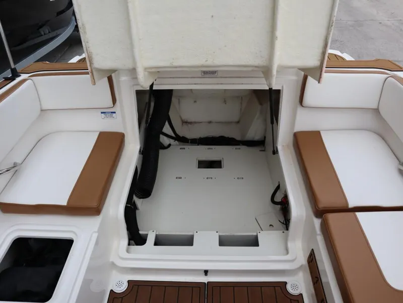 Slide: The Image of 2022 Bayliner VR4 Bowrider Outboard interior with open engine compartment and cushioned seating. - 17