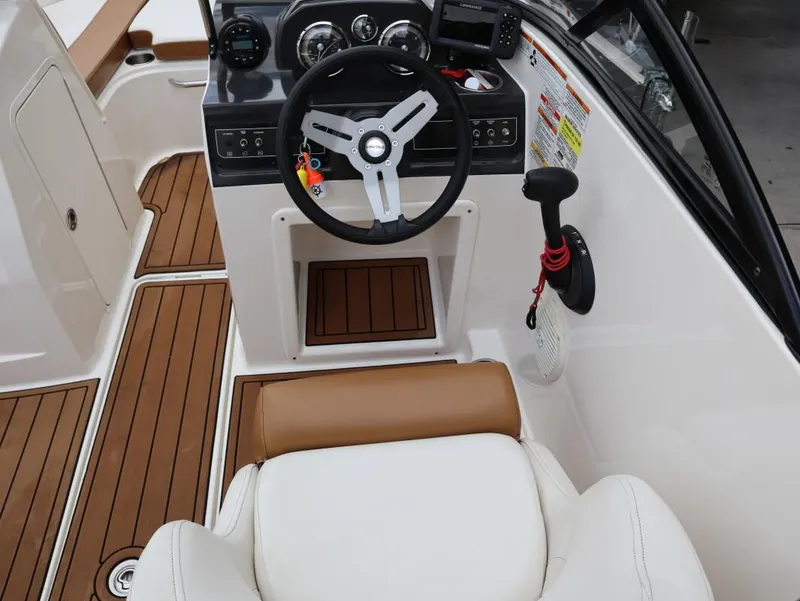 Slide: The Image of 2022 Bayliner VR4 Bowrider Outboard cockpit with steering wheel and control panel. - 20