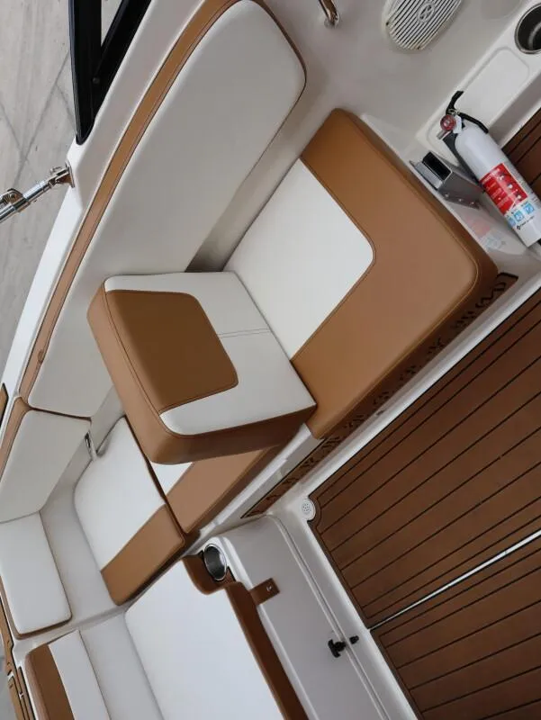 Slide: The Image of 2022 Bayliner VR4 Bowrider Outboard interior with tan and white seating, fire extinguisher visible. - 21
