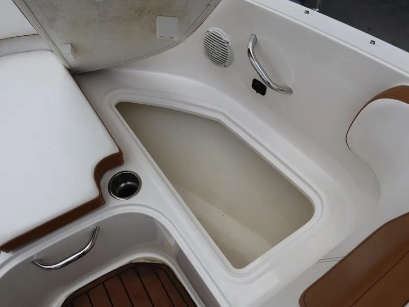 Slide: The Image of 2022 Bayliner VR4 Bowrider Outboard interior storage compartment with cup holder and handle. - 22