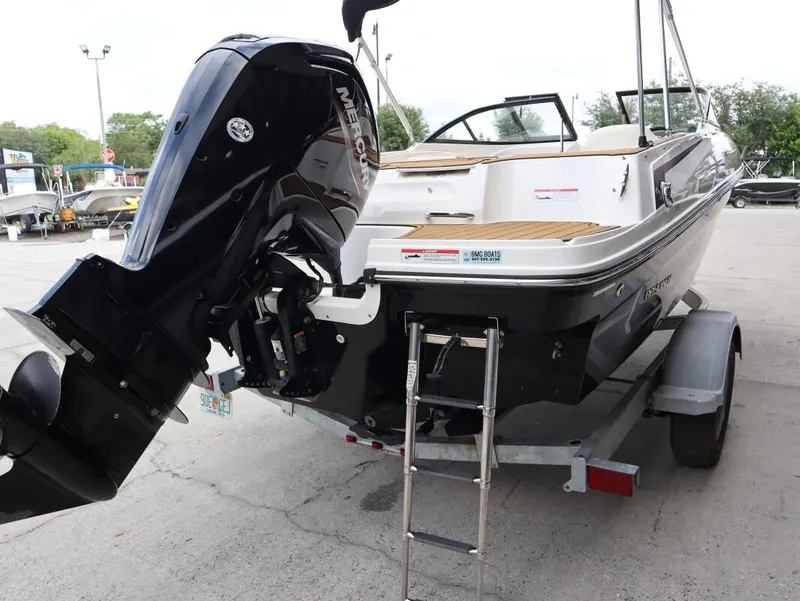Slide: The Image of 2022 Bayliner VR4 Bowrider Outboard on trailer, featuring a powerful Mercury engine. - 5