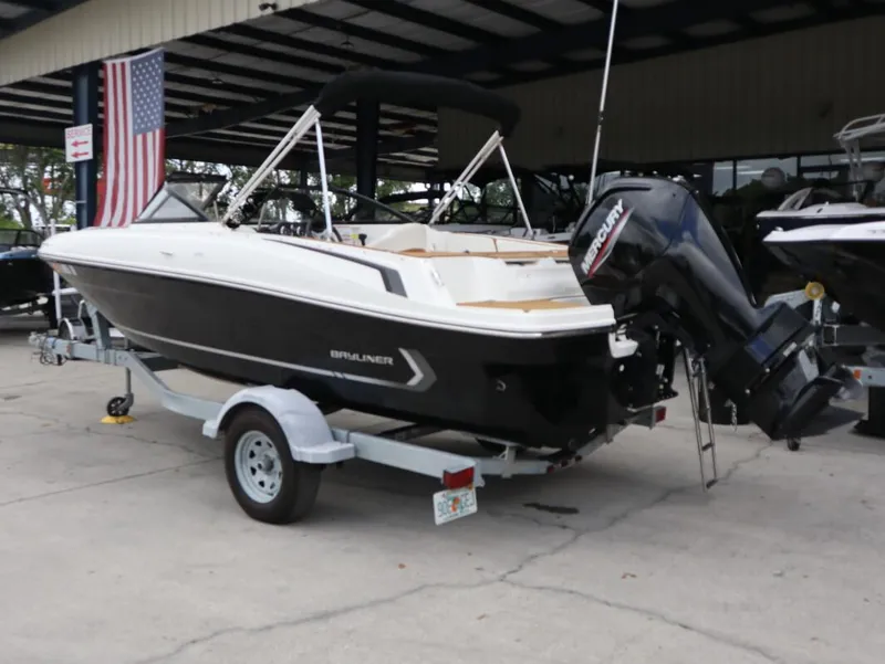 Slide: The Image of 2022 Bayliner VR4 Bowrider Outboard on trailer, displayed outdoors with American flag. - 6