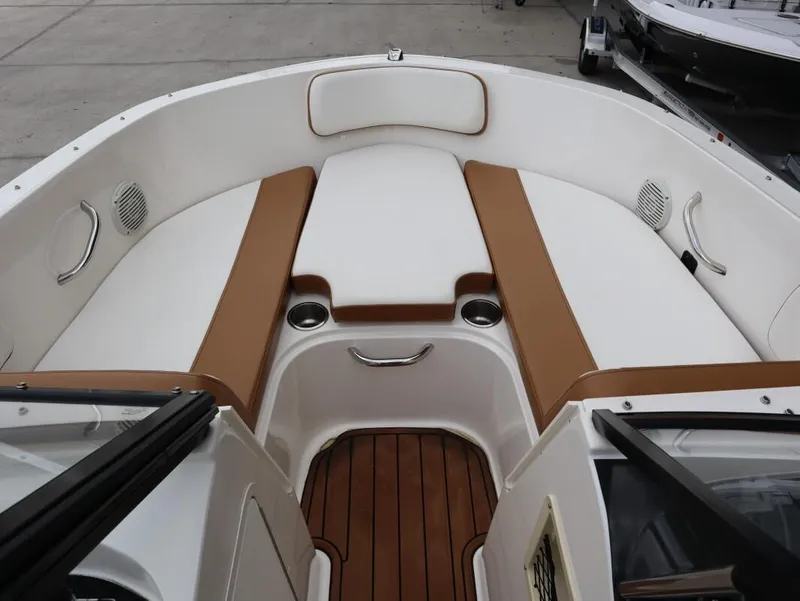 Slide: The Image of 2022 Bayliner VR4 Bowrider Outboard interior with tan and white seating. - 9