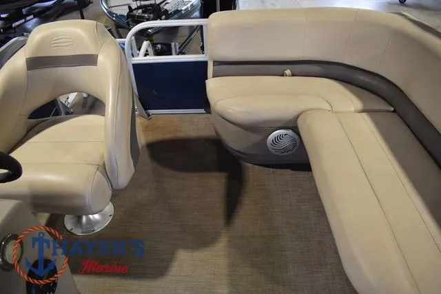 Slide: The Image of 2020 Sun Tracker Bass Buggy® 16 XL interior with beige seating and steering console. - 10