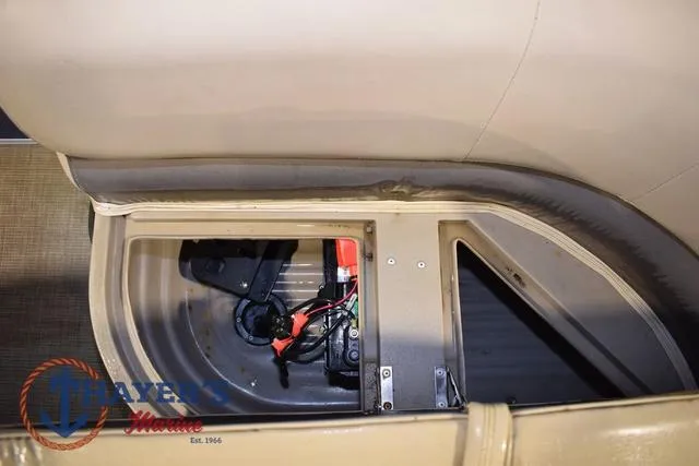 Slide: The Image of 2020 Sun Tracker Bass Buggy® 16 XL interior compartment with visible wiring and components. - 16