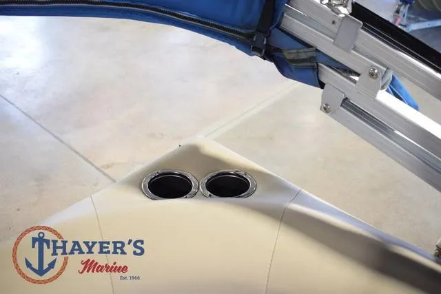 Slide: The Image of 2020 Sun Tracker Bass Buggy® 16 XL boat interior with cup holders and Thayer's Marine logo. - 18