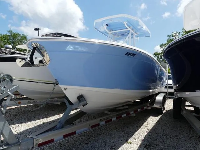 Slide: The Image of 2021 Blackfin 252CC boat on trailer, displayed outdoors under a clear blue sky. - 1