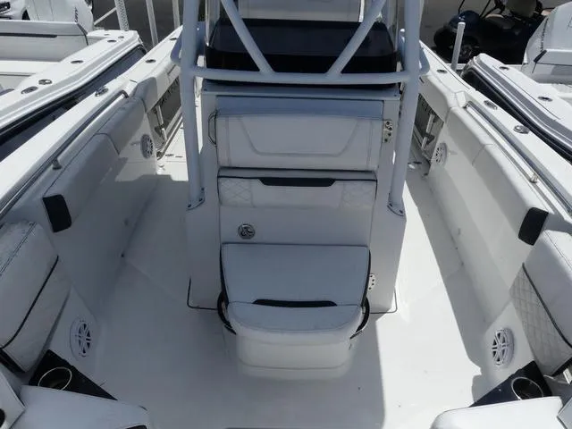 Slide: The Image of 2021 Blackfin 252CC boat interior with white seating and storage compartments. - 16