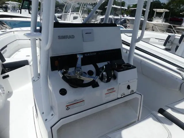 Slide: The Image of 2021 Blackfin 252CC boat console with Simrad electronics and steering wheel. - 7