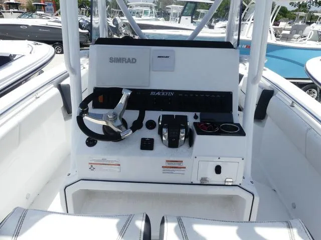 Slide: The Image of 2021 Blackfin 252CC boat console with steering wheel and controls. - 8