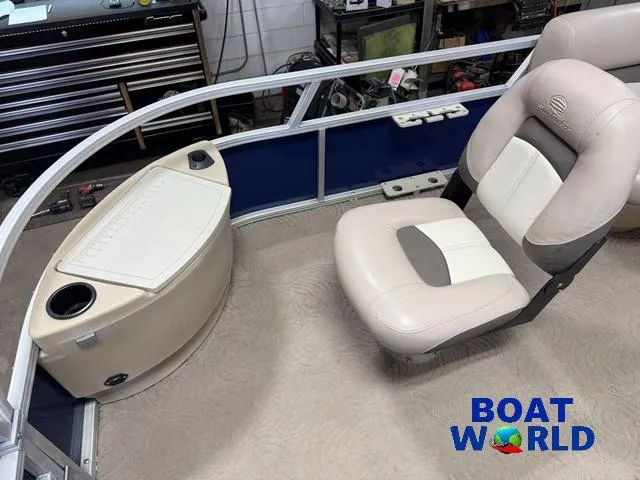 Slide: The Image of 2014 Sun Tracker 24' Fishin Barge Pontoon interior with seating and storage. - 10