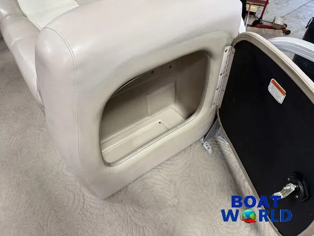 Slide: The Image of 2014 Sun Tracker Fishin Barge pontoon storage compartment, open, with beige upholstery. - 14
