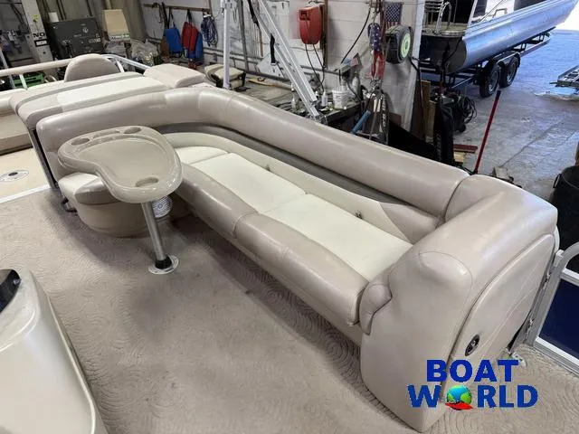Slide: The Image of 2014 Sun Tracker 24' Fishin Barge Pontoon interior with beige seating and table. - 15