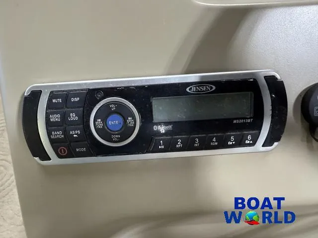 Slide: The Image of Jensen audio system on 2014 Sun Tracker 24' Fishin Barge Pontoon, Boat World logo visible. - 18