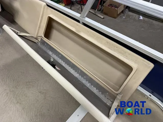 Slide: The Image of 2014 Sun Tracker 24' Fishin Barge Pontoon storage compartment, beige interior, Boat World logo visible. - 29