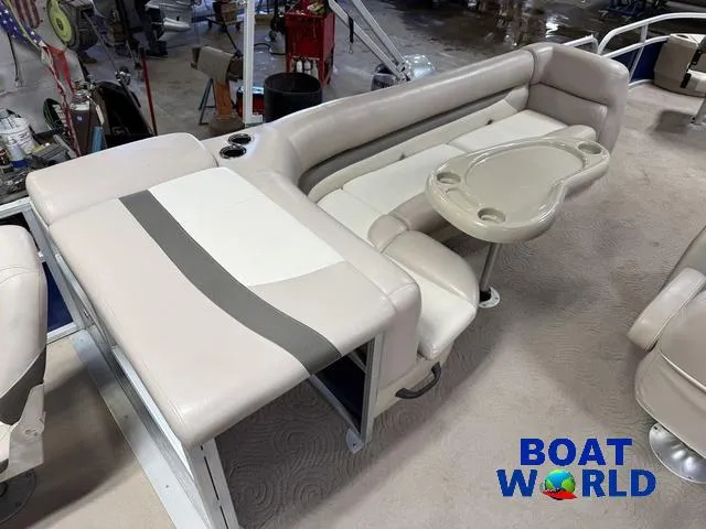 Slide: The Image of 2014 Sun Tracker 24' Fishin Barge Pontoon interior with seating and table, Boat World logo. - 32