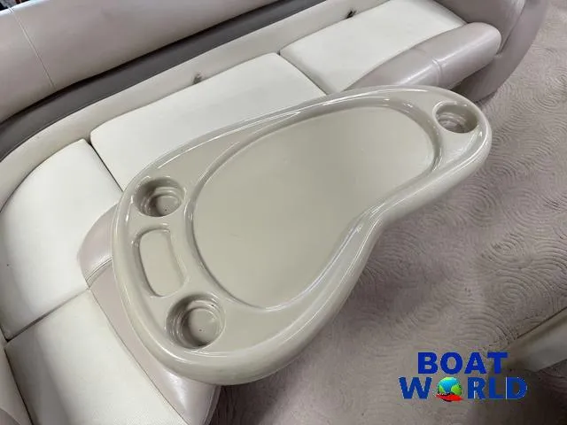 Slide: The Image of 2014 Sun Tracker Fishin Barge pontoon boat interior with beige cup holder table. - 33