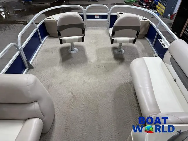 Slide: The Image of 2014 Sun Tracker 24' Fishin Barge Pontoon interior with seating and carpeted floor. - 34