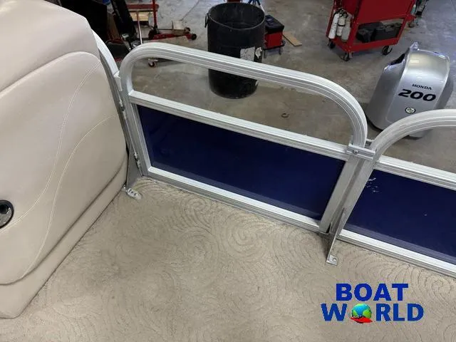 Slide: The Image of 2014 Sun Tracker Fishin Barge pontoon interior with beige seating and blue paneling. - 35