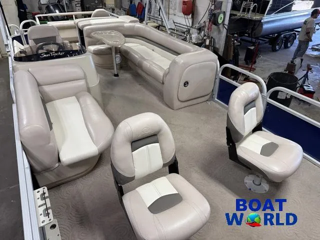Slide: The Image of 2014 Sun Tracker 24' Fishin Barge Pontoon interior with seating, in a workshop setting. - 36