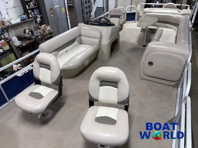 Slide: The Image of 2014 Sun Tracker 24' Fishin Barge Pontoon interior with seating and console, Boat World logo visible. - 37