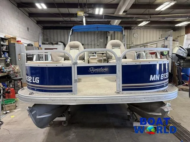 Slide: The Image of 2014 Sun Tracker 24' Fishin Barge Pontoon with Mercury 150HP in a workshop setting. - 38