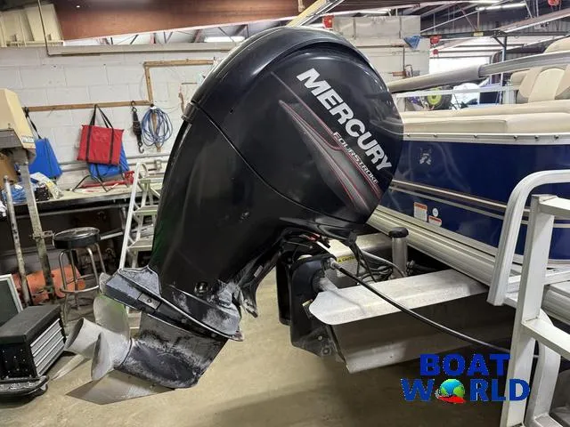Slide: The Image of 2014 Sun Tracker pontoon with Mercury 150HP 4-Stroke engine in a workshop setting. - 43