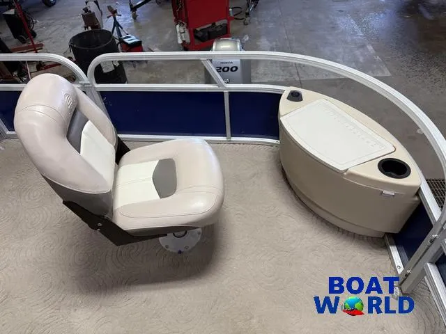 Slide: The Image of 2014 Sun Tracker 24' Fishin Barge Pontoon interior with seating and storage. - 8