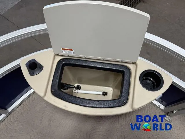 Slide: The Image of 2014 Sun Tracker Fishin Barge pontoon boat livewell with cup holders, Boat World logo visible. - 9