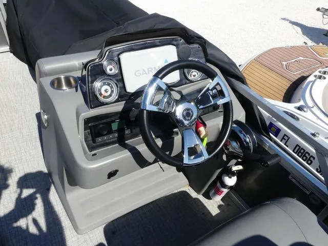 Slide: The Image of 2022 Avalon Catalina Platinum Quad Lounger dashboard with Garmin navigation system and steering wheel. - 12