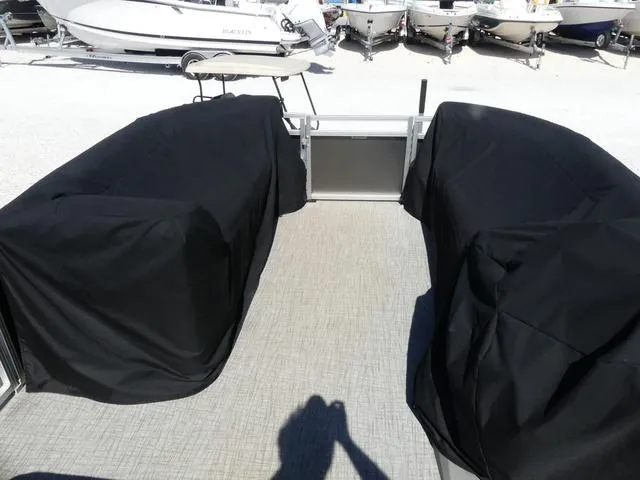 Slide: The Image of 2022 Avalon Catalina Platinum Quad Lounger 23 FT with covered seating, docked among other boats. - 9
