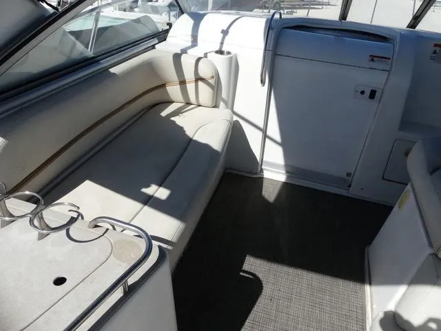 Slide: The Image of 2005 Larson 330 Cabrio boat interior with white seating and cup holders. - 10