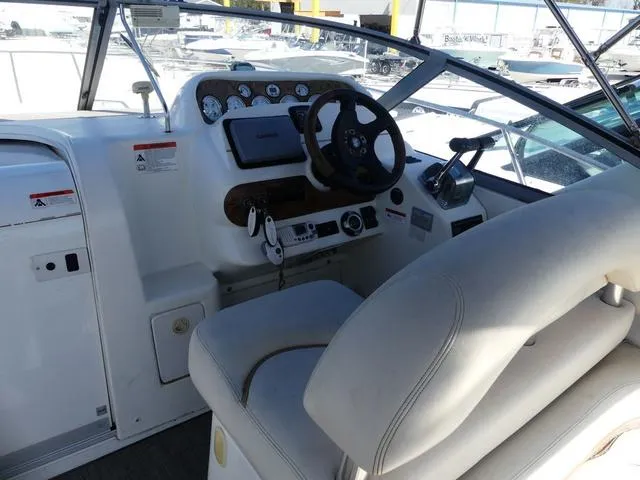 Slide: The Image of 2005 Larson 330 CABRIO boat cockpit with steering wheel and control panel. - 11