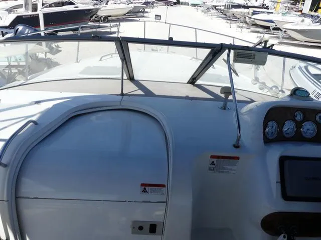 Slide: The Image of 2005 Larson 330 Cabrio boat dashboard with gauges and windshield in marina setting. - 14