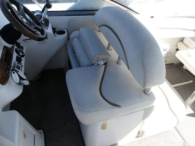 Slide: The Image of 2005 Larson 330 CABRIO boat interior with white seating and steering wheel. - 16