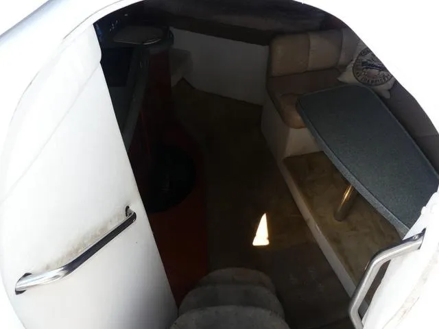 Slide: The Image of Interior view of 2005 Larson 330 CABRIO boat, featuring seating and a table. - 17