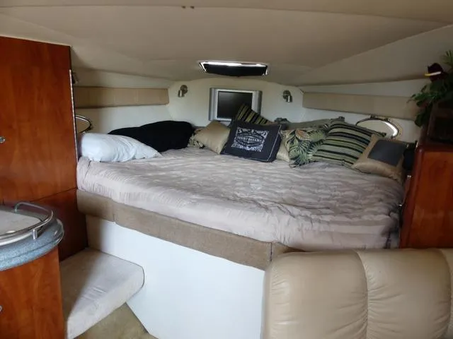 Slide: The Image of Interior cabin of 2005 Larson 330 Cabrio with cozy bed and pillows. - 19