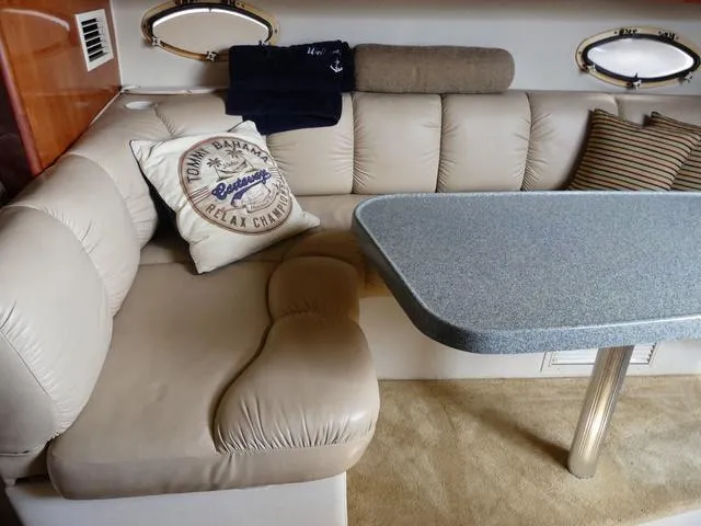 Slide: The Image of 2005 Larson 330 Cabrio interior with beige seating and a gray table. - 20