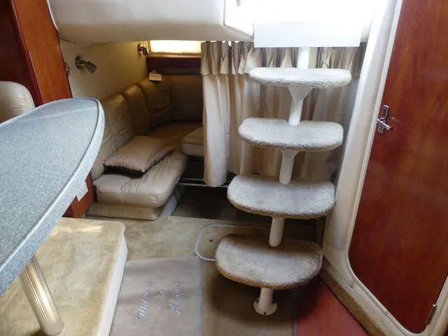 Slide: The Image of Interior of 2005 Larson 330 CABRIO boat with cozy seating and carpeted stairs. - 22